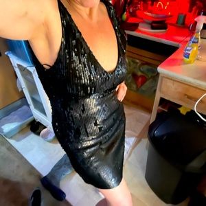 This is a black sequins party dress Lovy scoop in the back small slit on leg